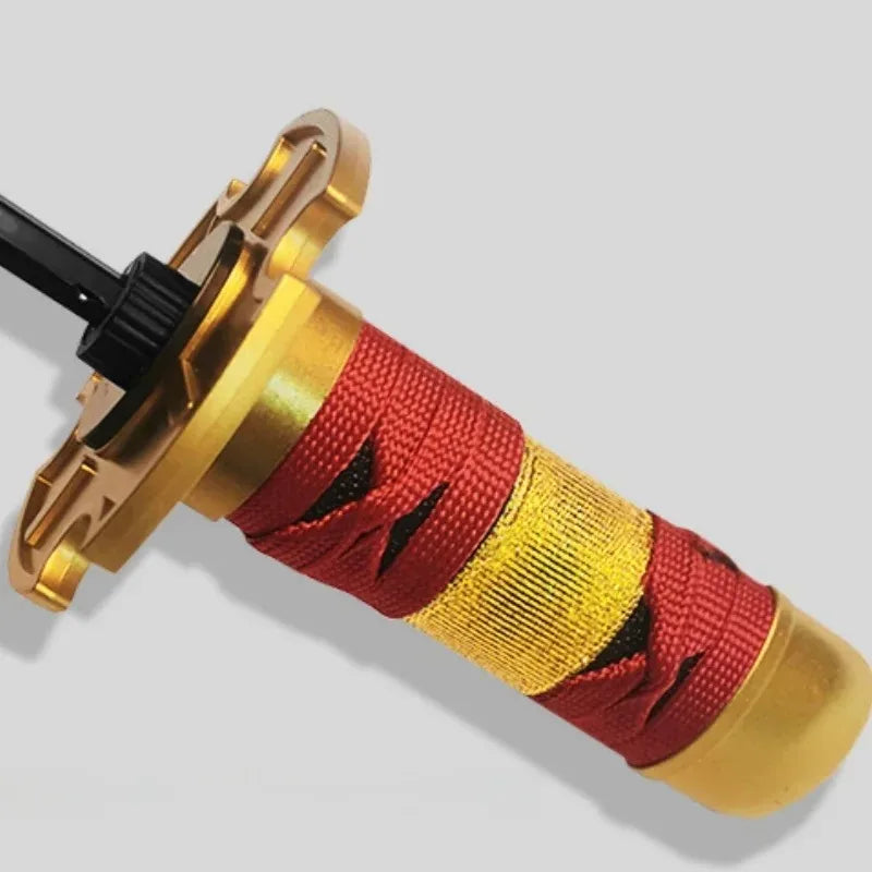 A close-up view of a Demon Slayer Katana 3-fold umbrella with gold accents and red fabric wrapping.