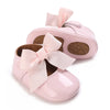 Pink lace-trimmed baby girl moccasin shoes with a pink bow