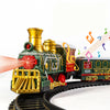 A miniature musical train set featuring a green locomotive with gold accents, tracks, and musical notes.