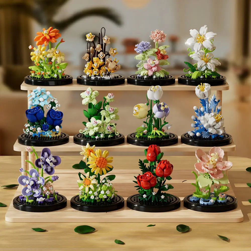 A collection of buildable eternal rose flower kits featuring various colored and styled flowers on black bases.
