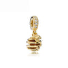 Gold charm bracelet featuring pendants of an elephant, key, butterfly, and heart.