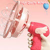 A pink electric bubble machine is shown being held by a hand, with bubbles being blown out.