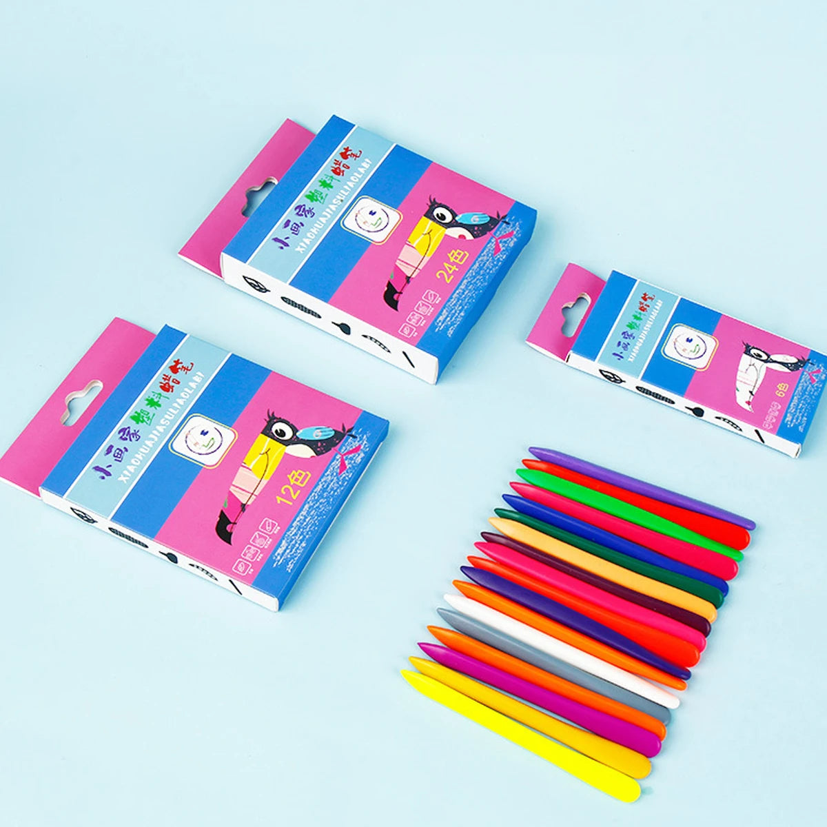 A collection of colorful triangular crayons in various shades arranged on a light blue surface.