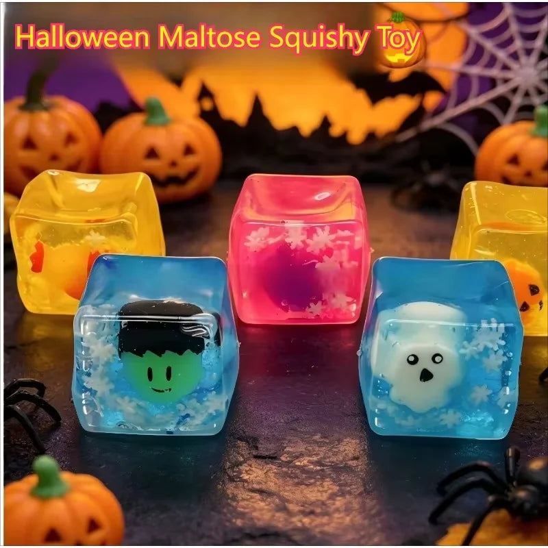 A set of translucent ice cube squishy toys shaped like ghosts and other Halloween figures on a dark surface.