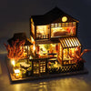 A detailed wooden mini seaside villa dollhouse kit featuring furniture and decorative elements.