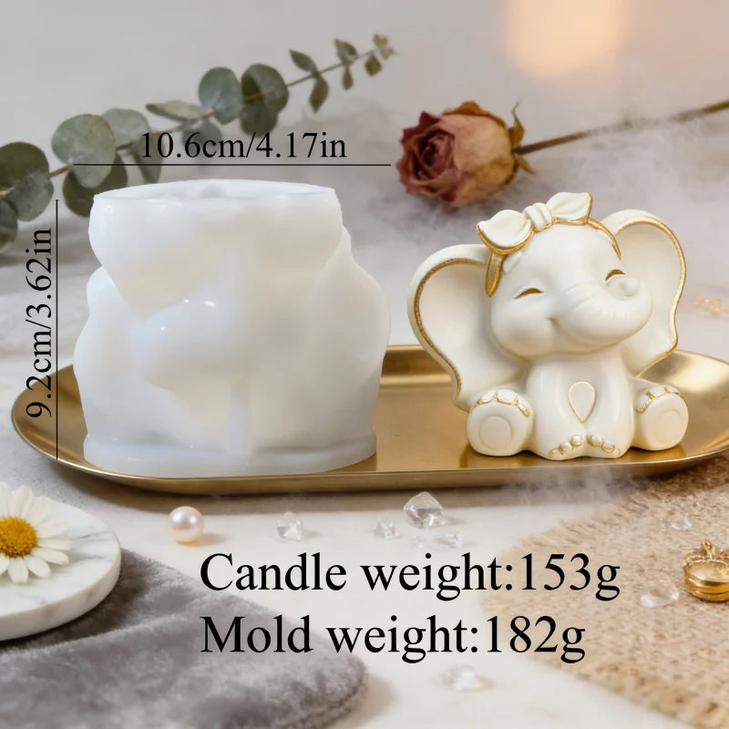 A white silicone mold shaped like an elephant is displayed next to a finished candle and various natural elements.