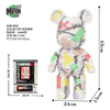 A small bear figure made of micro building blocks in various colors and patterns.