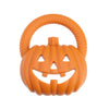 An orange silicone pumpkin baby teether with a carved face and textured grip.
