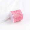 A roll of pink macrame cord for jewelry making and crafts.