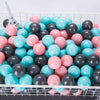 A collection of colorful plastic play balls in various shades of pink, blue, and gray are displayed in a white wire basket.