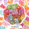A pile of pastel bear-shaped acrylic craft beads in various colors like pink, green, orange, and yellow.