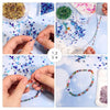 Hands are assembling colorful faceted crystal bicone glass beads for jewelry making.