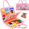 A pink Montessori busy board for toddlers featuring various colorful manipulative items and a matching tote bag.