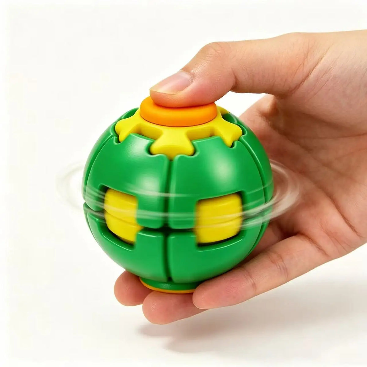 A hand holds a green fidget spinner ball with yellow accents, demonstrating its smooth rotating motion.