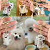 A collection of dog-shaped pet hair keepsakes and keychains featuring various breeds and colors.