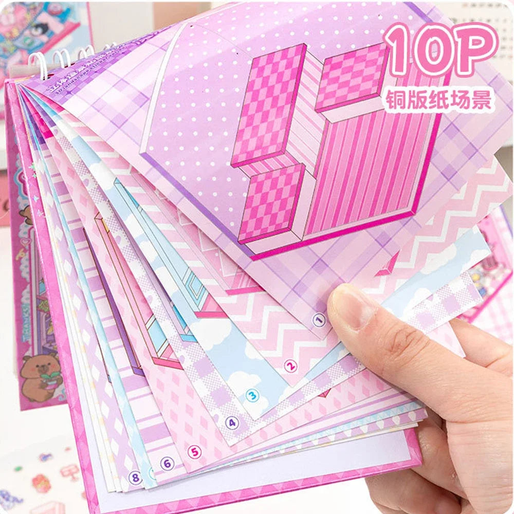 A hand holds a stack of 10P pink and purple 3D stacking miniature scene stickers featuring geometric buildings.