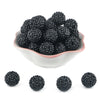 A pile of black rhinestone acrylic beads for jewelry making