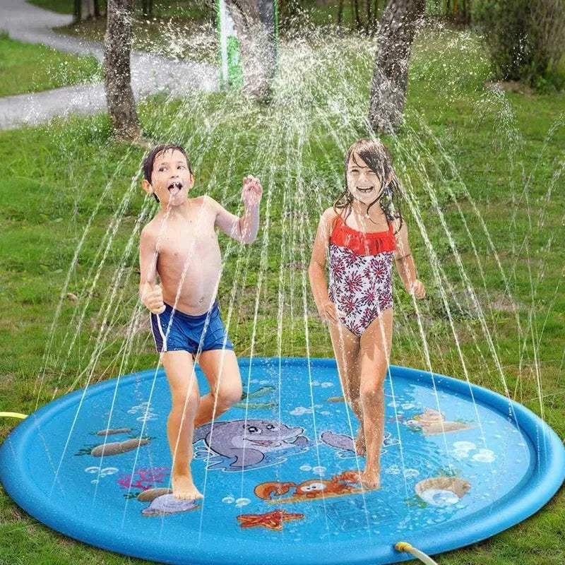 Two children are playing in a blue inflatable sprinkler mat outdoors on a grassy lawn.