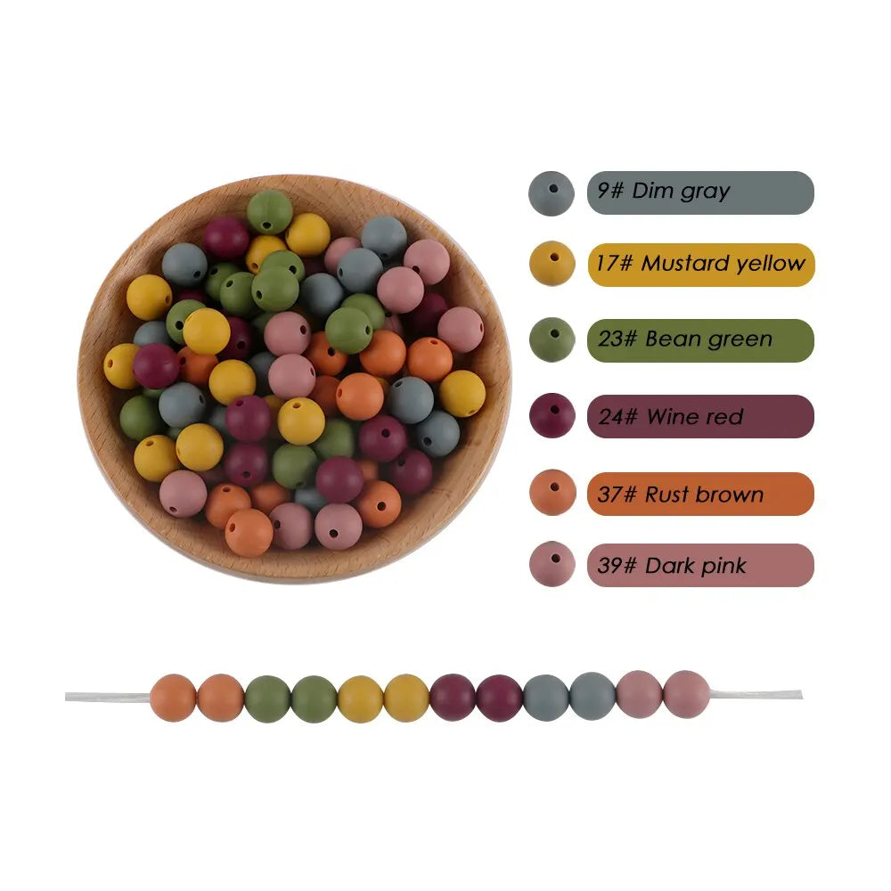 A collection of round silicone beads in various colors including gray, yellow, green, red, and pink, displayed next to a stri