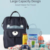 A navy blue waterproof diaper backpack shown with various baby essentials like wipes, diapers, and a changing mat.