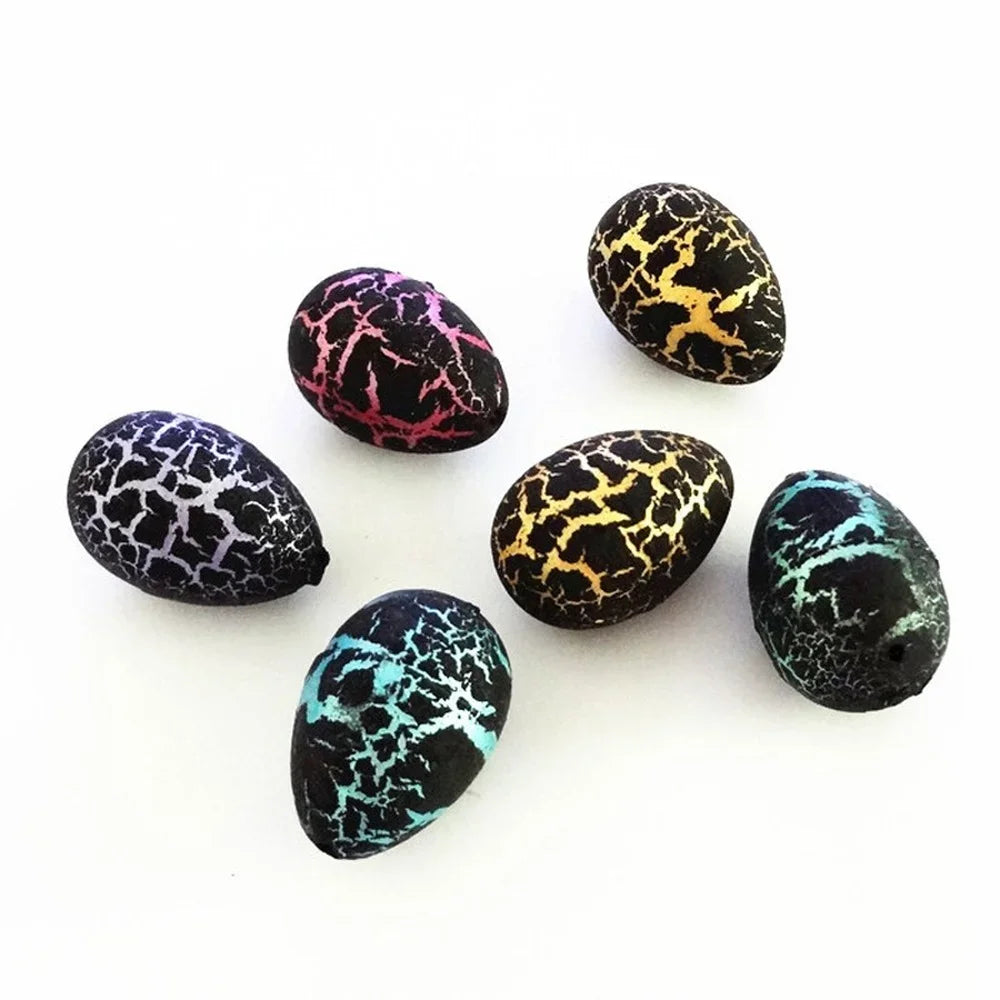 A collection of speckled dinosaur eggs in black, yellow, and teal colors.