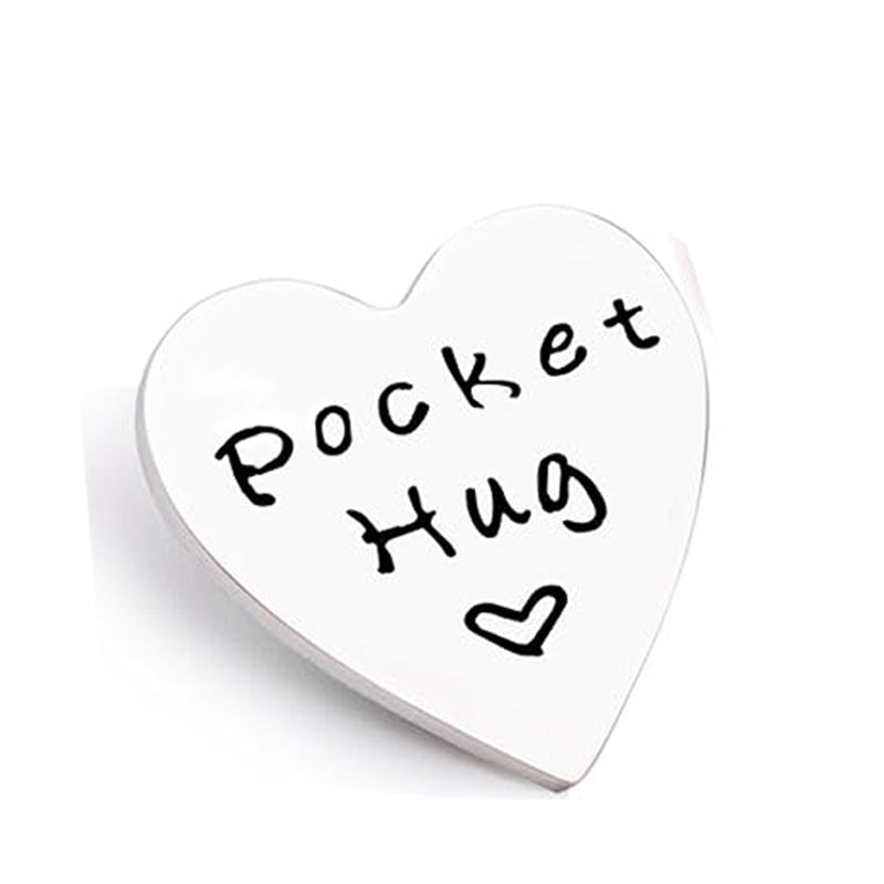 A white heart-shaped token with the words Pocket Hug written in black script.
