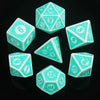 A collection of teal polyhedral dice, including a d20 and d12, displayed on a reflective black surface.