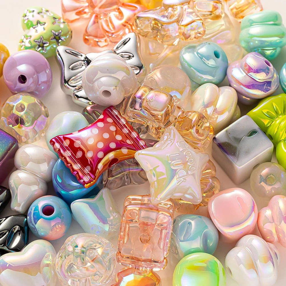 A close-up of various colorful Y2K acrylic bow and flower beads used for DIY jewelry making.
