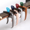 A set of professional metal guitar capos with colored pick holders mounted on a wooden fretboard.