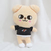 A light beige cartoon animal plush toy with large eyes and a black shirt.