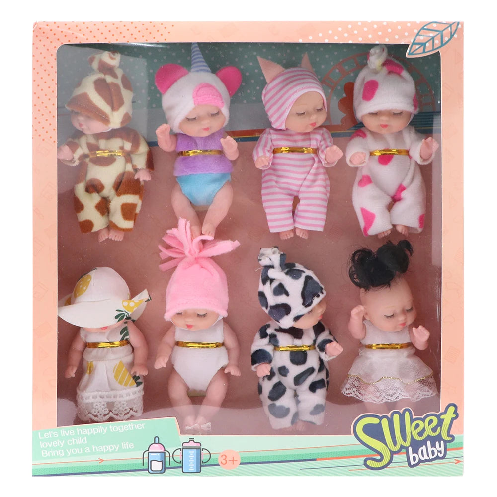 A set of realistic mini reborn baby dolls with outfits and accessories displayed in packaging.