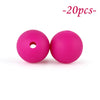Two bright pink silicone beads, one hollow and one solid, are shown against a white background.