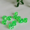 A collection of bright green transparent dice scattered on a white surface.