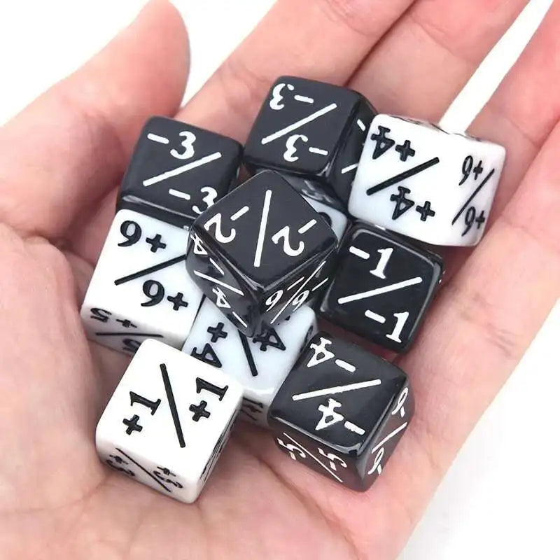 A hand holds a set of ten dual-color counting dice showing various positive and negative numbers.