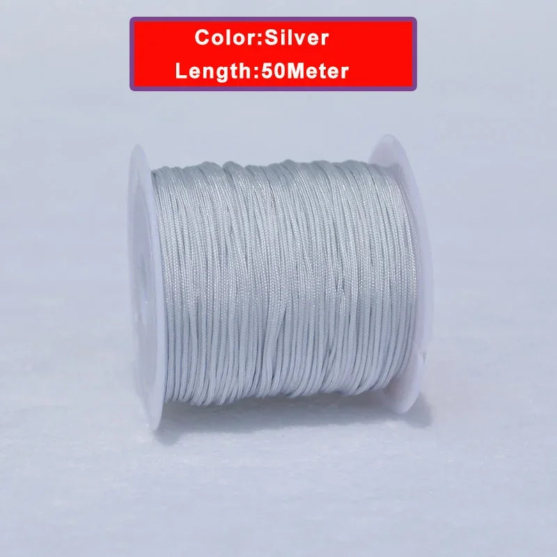 Silver nylon knotting cord for jewelry making, 50 meters long and wound on a spool.