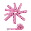 A pink tape measure set with multiple rulers and a roll of measuring tape shown against a white background.