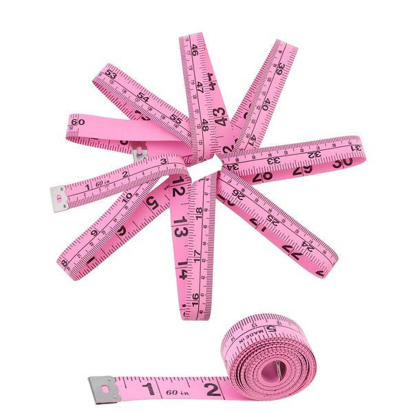 A pink tape measure set with multiple rulers and a roll of measuring tape shown against a white background.