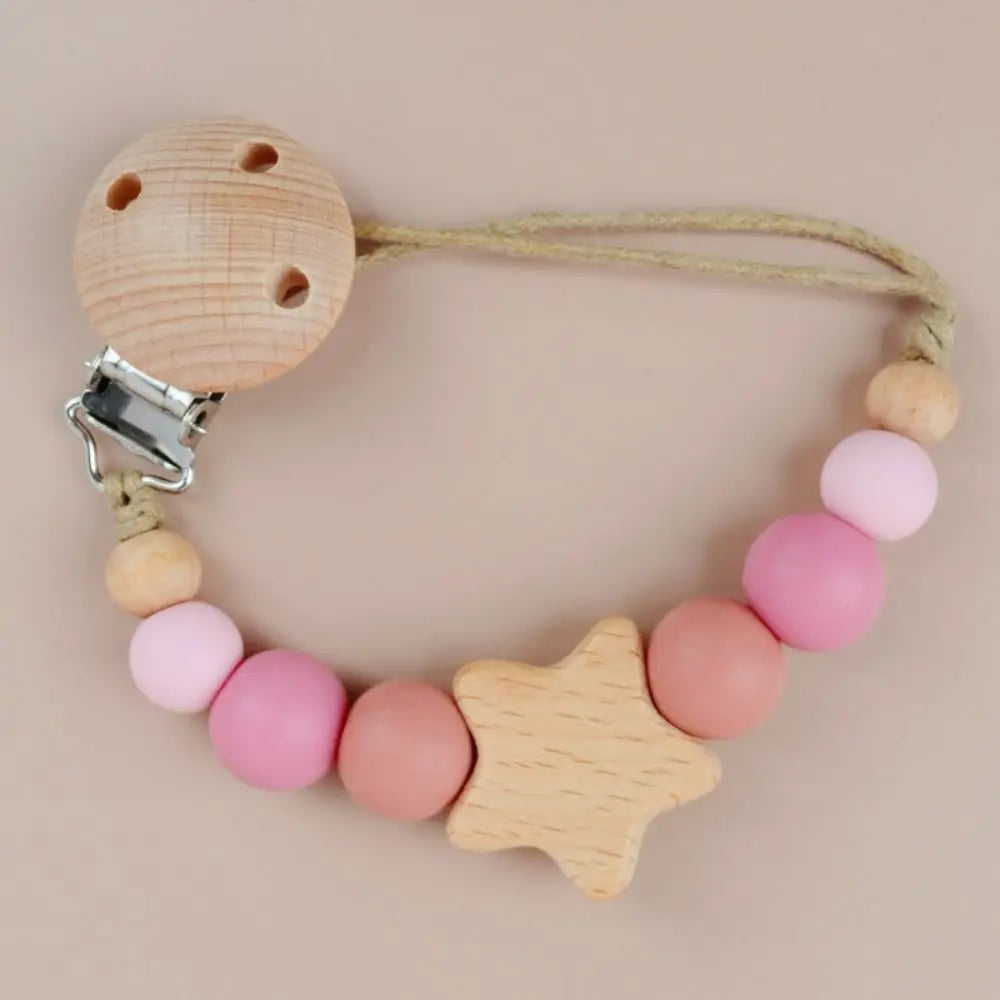 A wooden pacifier clip featuring silicone beads and a star shape for a baby.
