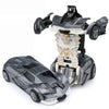 A black transforming car robot toy with a white and gray design, showing both the vehicle and robot modes.