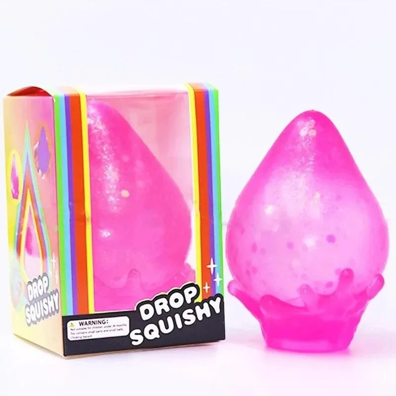 A pink squishy toy shaped like a raindrop is shown in its packaging.
