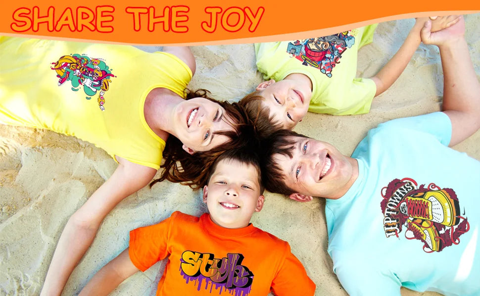 Five children lying on sand smiling while wearing colorful t-shirts