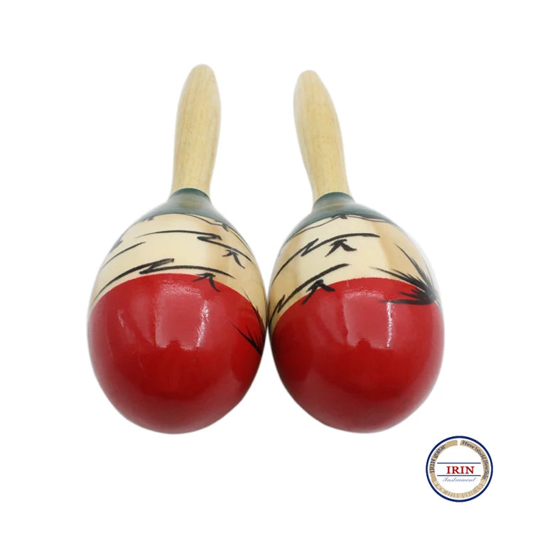 A pair of hand-painted wooden maracas with light wood handles and red bodies.