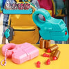 A pink mini shell-ejecting fidget pistol and several small red and brown cylindrical objects are displayed on a yellow surfac
