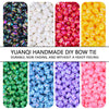 Assortment of colorful acrylic bow beads in various shades including black, white, pink, yellow, blue, and purple.