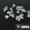 A collection of clear, translucent building block pieces resembling coins or gems, displayed on a dark surface.
