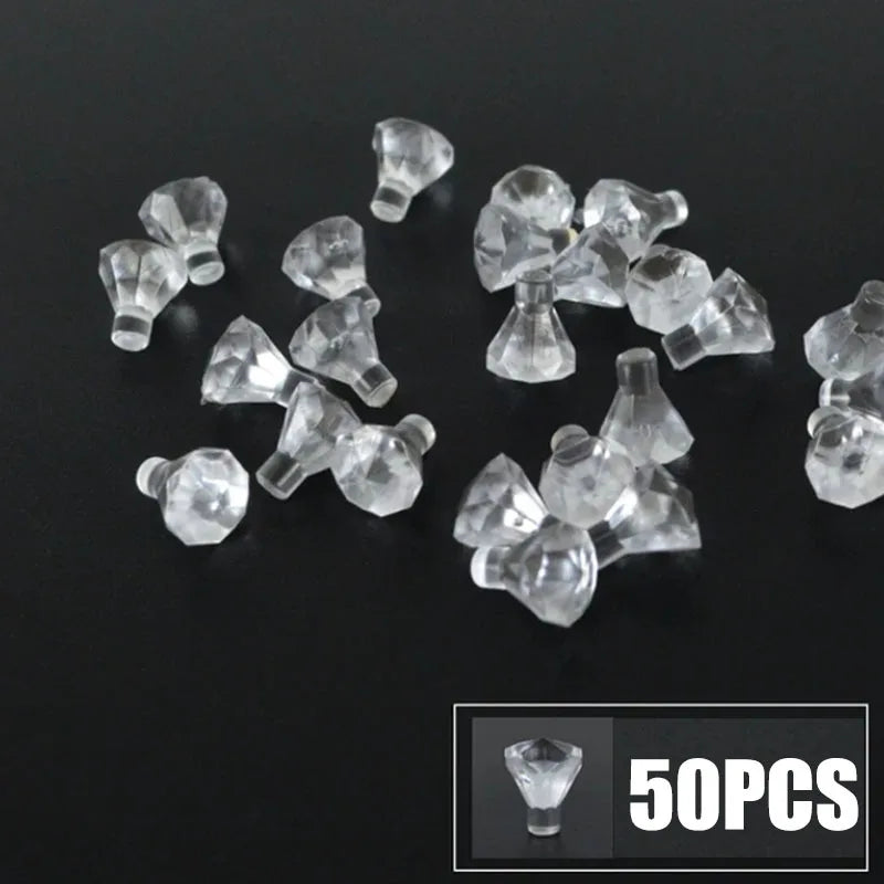 A collection of clear, translucent building block pieces resembling coins or gems, displayed on a dark surface.