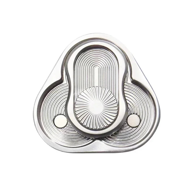 A silver metal fidget slider with concentric grooves and a central protrusion for stress relief.