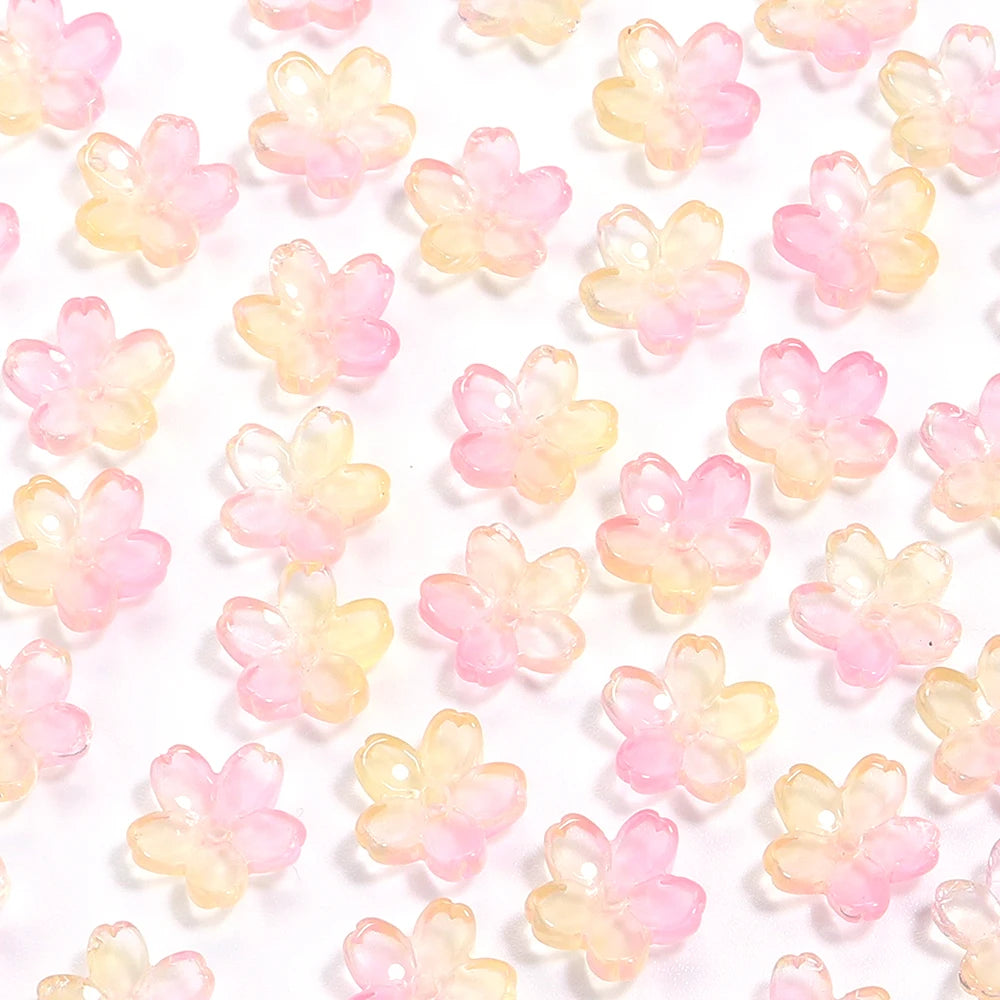 A collection of pink and yellow cherry blossom flower glass beads for jewelry making