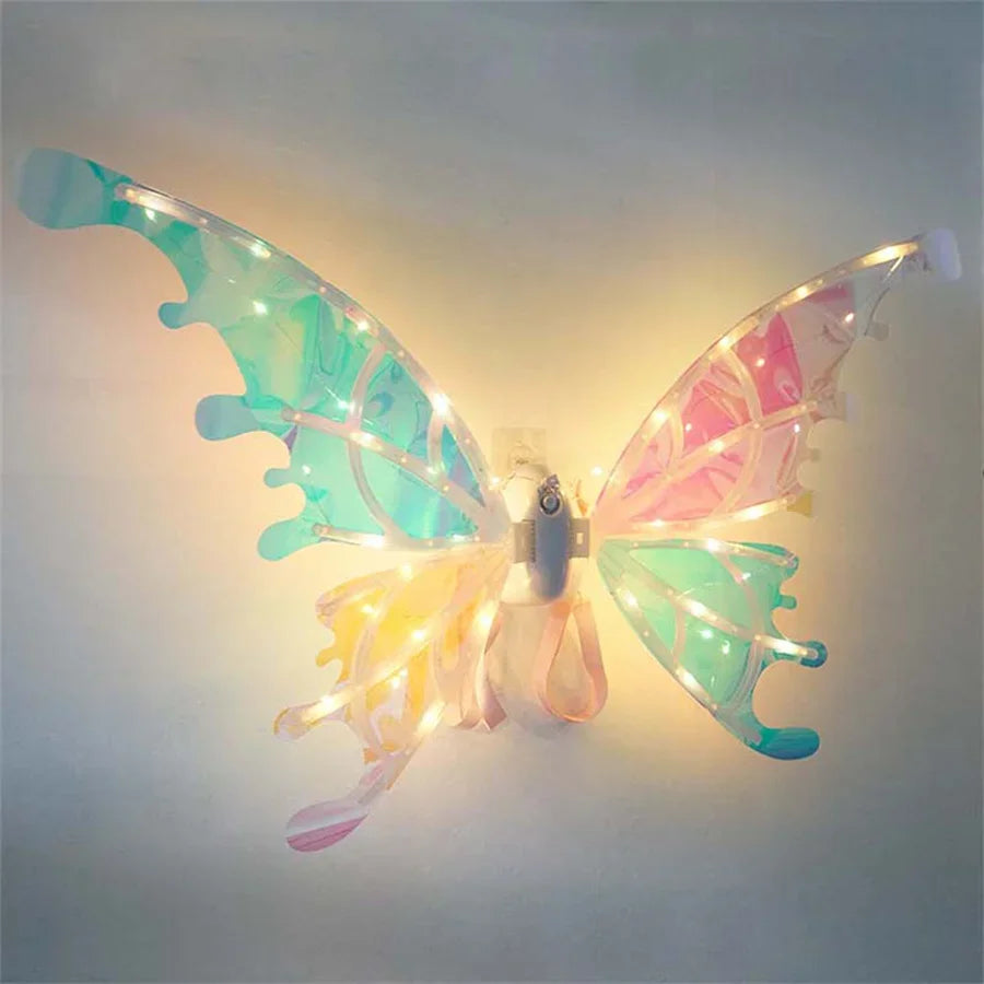A pair of glowing fairy wings, featuring iridescent blue and pink light, displayed against a light background.