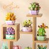 A set of miniature flower bouquets built with wooden blocks, featuring pink, yellow, and green flowers.